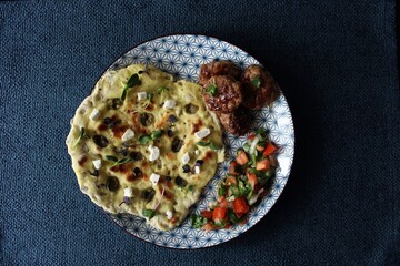Greek grill meatball on pita with tomato and cucumbers