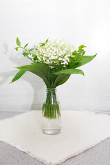 lily on wooden background. Bouquet of flowers in a vase