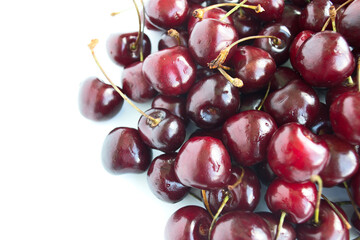 Background from ripe cherries on a white background. The effect of blurry berries. Copy space