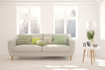 White stylish minimalist room with sofa and winter landscape in window. Scandinavian interior design. 3D illustration