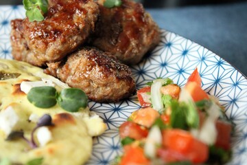 Greek grill meatball on pita with tomato and cucumbers
