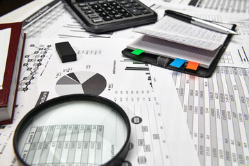 Top view of office employee's desk - work with financial reports, analysis and accounting, tables...