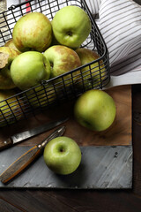 Garden green apples in a metal basket on the table