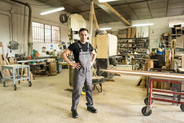 Worker looking at camera in a factory.