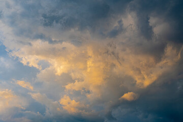 Glimmers of sunlight in stormy clouds at sunset.