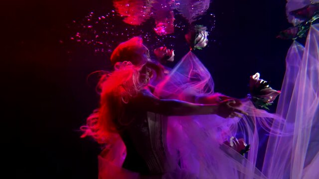 woman is swimming underwater in large aquarium, fairy tale and magic concept