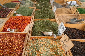 Lots of spices, nuts and condiments on the counter with price tags
