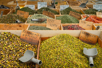Lots of spices, nuts and condiments on the counter with price tags