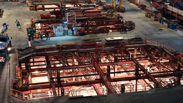 4K Night time lapse of skyscraper building basement construction site