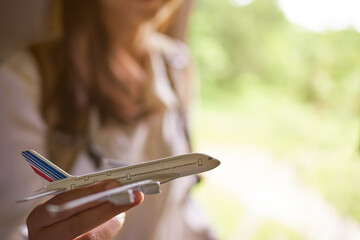 The concept of tourism, the image of a girl with a close-up of an airplane