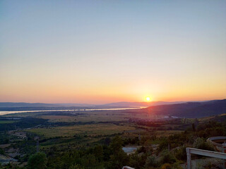 Abandoned factory and power plant  made mostly out of brick walls at sunset near Danube River, deep orange sun vibes shining on the leftovers  
