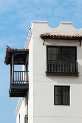 Fototapeta na wymiar Colonial style house with dark wooden balcony