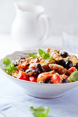Penne pasta baked with pork tenderloin, cherry tomatoes, black olives and cheese. Close up. 