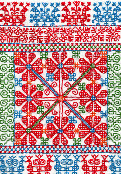 Traditional russian folk handmade red thread embroidery at natural white linen with cotton insertion. Part of a towel with traditional ornament that was used as clothes belt in national costume.