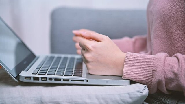 Close up frustrated woman hands typing on keyboard punching keyboard with fist Concept of failure