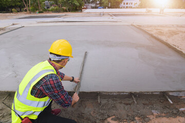 Fototapeta premium Cement Concrete Road Construction,Concrete pouring during commercial concreting floors of building