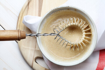 Whole-grain flour pancake dough in a ceramic bowl