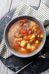 Tomato soup with potatoes, carrots, corn, barley and green onions