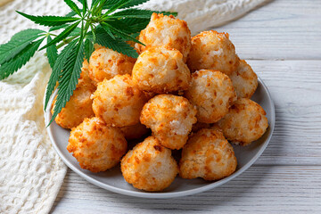 Cannabis and energy balls with marijuana on a white plate, concept of medical marijuana, home cooking. View from above