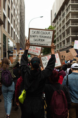 Attractive young female wearing a banner during the demonstrations in London against racisms and...