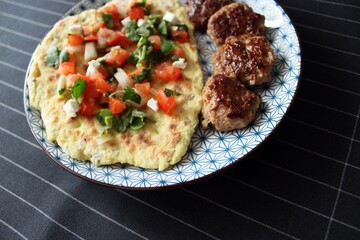 Greek grill meatball on pita with tomato and cucumbers