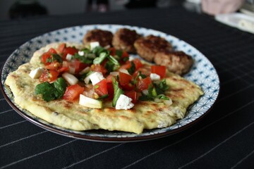 Greek grill meatball on pita with tomato and cucumbers