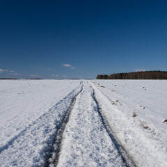Snow-covered dirt road.