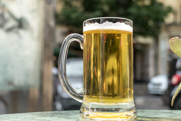 Beer tankard glass with white foam. Selective focus