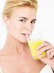 Young attractive blonde Woman Drinking Orange Juice