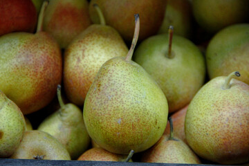 Green fresh pears with red dots on them