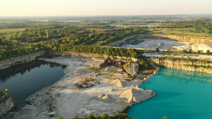 Aerial view of Stone Plant. Quarrying and manufacturing of natural stone products for building, construction, landscaping purposes. Industrial landscape, turquoise water, summertime, early morning, su