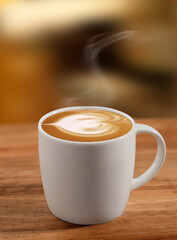 Cafe con leche sobre mesa de madera. Coffee with milk on a wooden table.