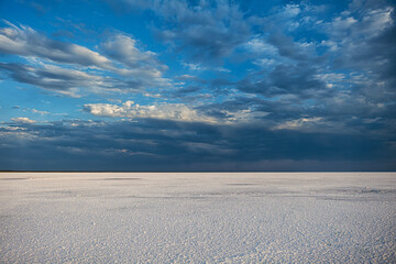 Elton salt lake covered with white salt with beautiful clouds at sunset
