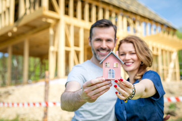 Couple make their dreams of building their own home come true with house under construction in background