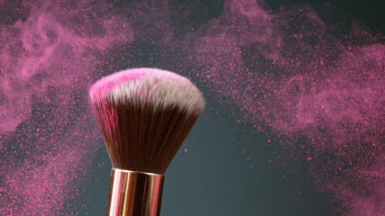 Makeup brush touch each other on dark background and small particles of cosmetics