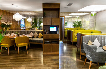 Interior of cozy modern restaurant with soft sofas and armchairs