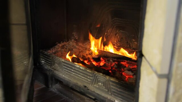 A man pours the powder into a burning fireplace