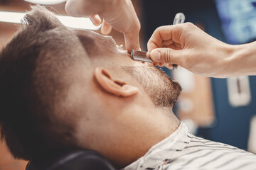 Obraz na płótnie Canvas Man hipster having barber shave razor blade barbershop