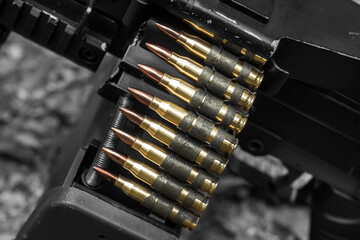 M249 light machine gun with 7.62 mm cartridge belt black and white