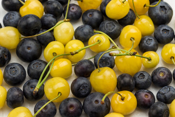 Fresh yellow cherry and Blueberry on white background.