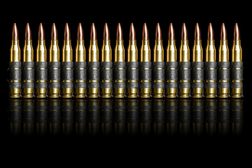 Bullet 5.56 mm chain ammunition isolated on black background - obrazy, fototapety, plakaty