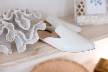 beautiful women's shoes on legs and layouts, leather white mules and loafers, in the interior of a room or office, a girl shoes, blue skirt and white shoes, a noble and elegant style, modern and trend