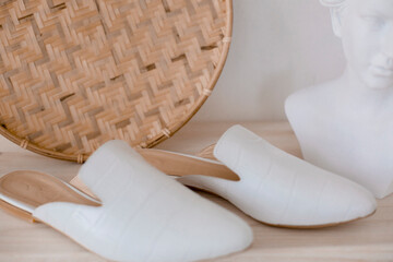 beautiful women's shoes on legs and layouts, leather white mules and loafers, in the interior of a room or office, a girl shoes, blue skirt and white shoes, a noble and elegant style, modern and trend