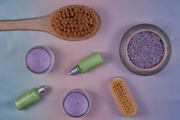 Flat lay of spa items on a pastel gradient background.