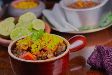 Beef curry with rice garnished and served with lime slices.