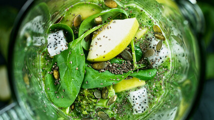 Green fresh smoothie blended in blender, top view. Healthy eating concept.