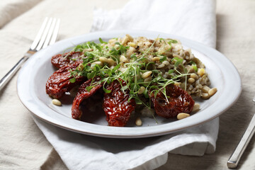 Braised brown rice, sprouted lentils and coconut milk with sun-dried tomatoes, micro-greens and pine nuts