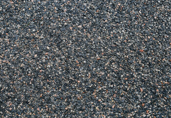 Gray grungy asphalt. The surface of the asphalt road. View from above.