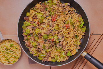 Flat lay of beef stir fry and vegetables,cooked and resting in a pan.