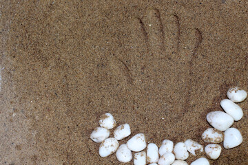 Fototapeta na wymiar hand print on sand symbol